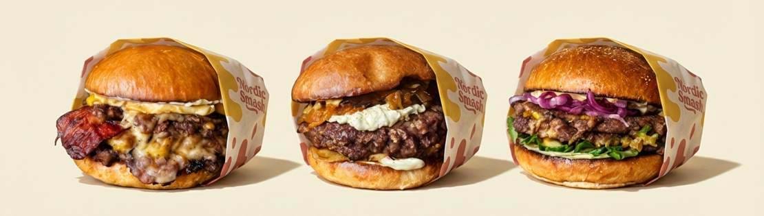 A Wide Facebook Cover Image With Three Nordic Smash Burgers Placed Side By Side On A Clean Cream Ba 0Pwwmrgw0hd9qzh4kulf 0