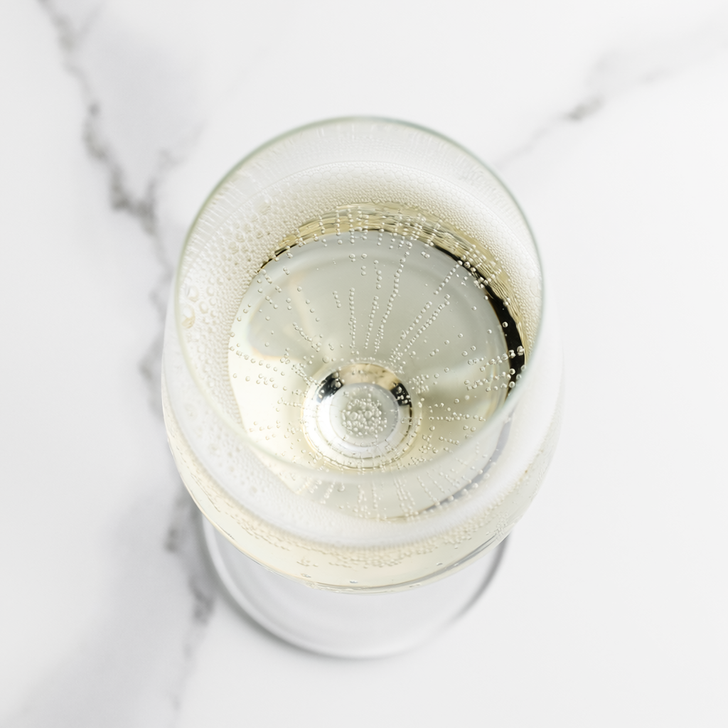 Firefly Spumante (Bobler) A Glass Of Sparkling White Wine On A White Marble Surface, Top Do 495101