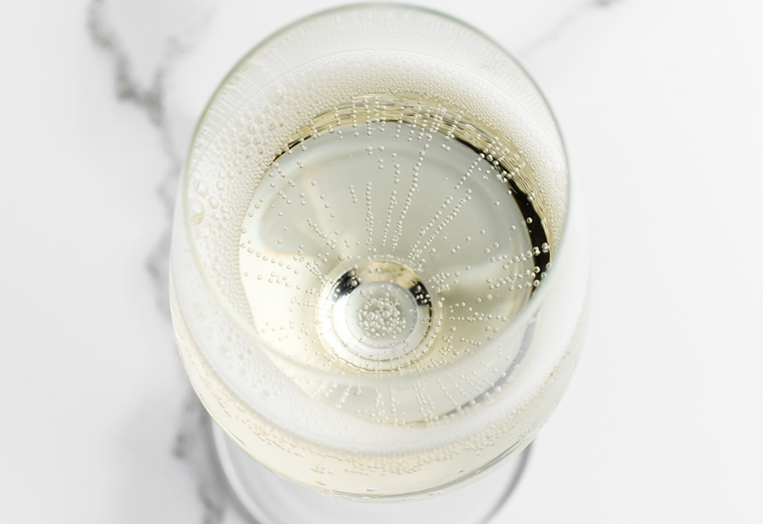 Firefly Spumante (Bobler) A Glass Of Sparkling White Wine On A White Marble Surface, Top Do 495101